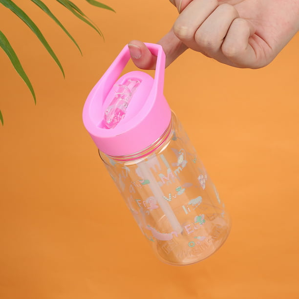 Agua con gas en vaso de plástico con pajita rosa. botella con agua fresca.