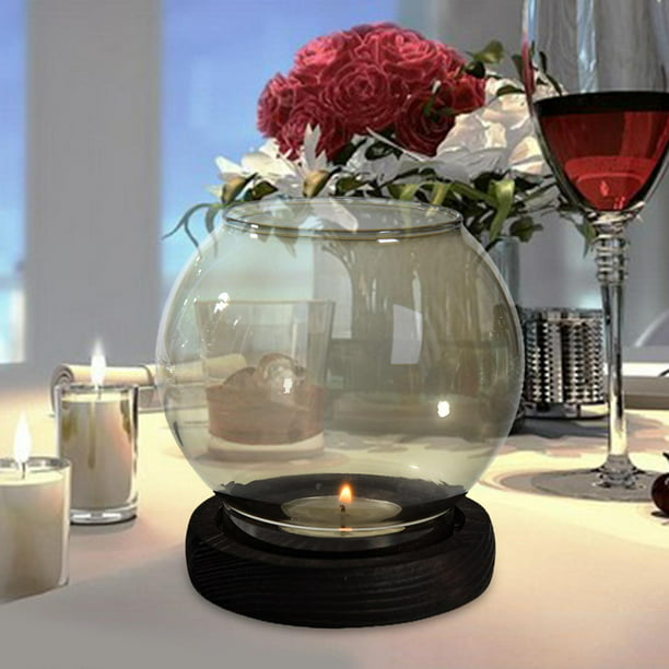 Una taza de cristal transparente con velas aromáticas sobre una