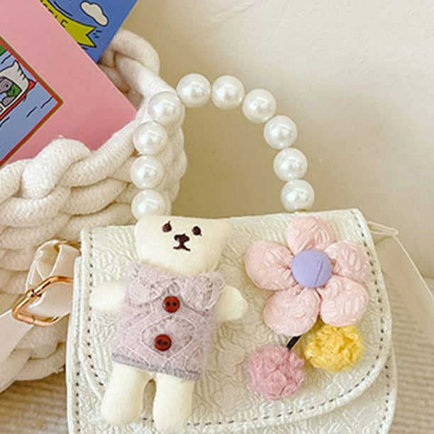Bolso de mano infantil niña color rosa adornado con muñequitas