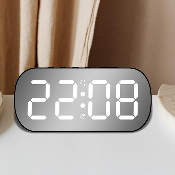 Reloj despertador digital moderno con signo de despertador sobre un fondo  blanco.