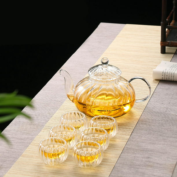 Teteras de vidrio transparente para té con té blanco y negro en la mesa del  café